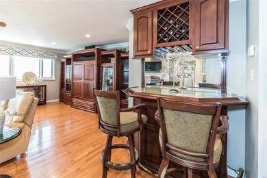 Gleaming hardwood flooring, plenty of space and nice card/bar will stay with the home. Not to mention the large windows.