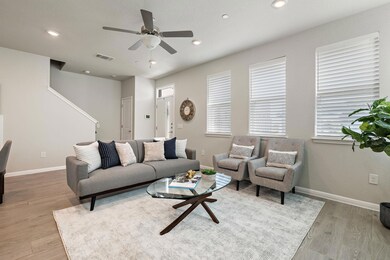 Living area with visible vents, baseboards, a cei