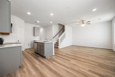 Kitchen with gray cabinetry, stainless steel appl