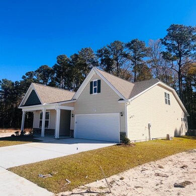 View of front of house featuring driveway, a garage, a shingled roof, a front yard, and stone siding
