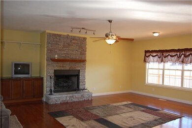 Another view of living room.  Hardwood floors and many windows make this a stunning room.  