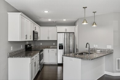 Granite counters and lots of cabinets for storage