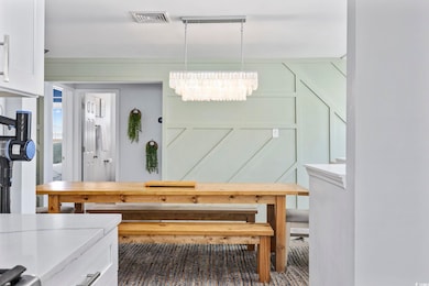 Dining area with visible vents and an inviting cha