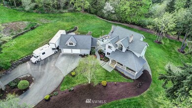 Amazing circular driveway, shy acre lot, Cascade & Olympic mountain VIEWS Home and detached garage surrounded by custom stamped concrete driveway and walkway.  Newer roof with county charm covered deck, gables sitting perfectly on this shy one acre lot with amazing views.