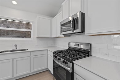 Kitchen with stainless steel appliances, light co