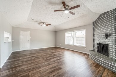 A beautiful view of the grand living room featuring all new flooring, a delicate paint job on the chimney to give it an amazing contrast that goes wonderfully with the new paint on the walls.