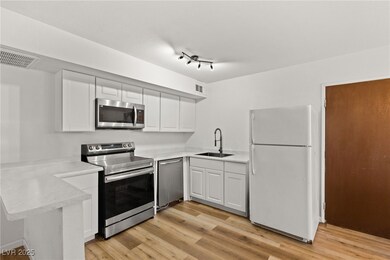 Kitchen featuring a peninsula, stainless steel app