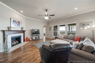 Hardwoods run into the open living room with soft