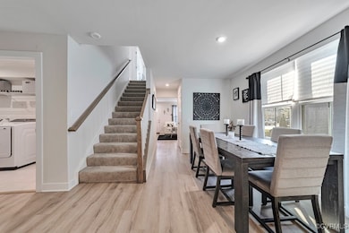 Dining space featuring stairs, light wood finished