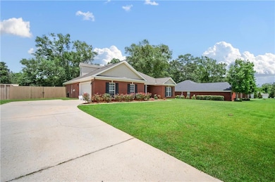 Single story home with concrete driveway, a garage, and brick siding