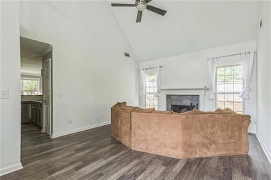 Living area with visible vents, dark wood-style fl