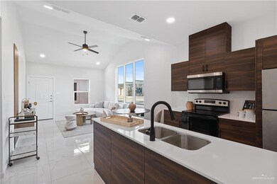 Kitchen featuring visible vents, a sink, light countertops, appliances with stainless steel finishes, and modern cabinets