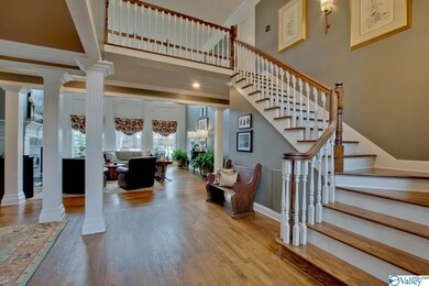 Foyer flows into the Great Room with Vaulted Ceiling and wall of Windows