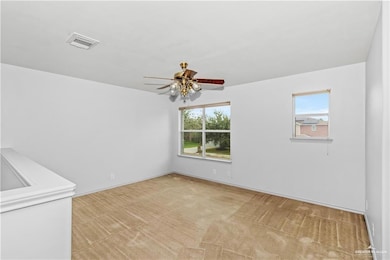 Spare room with light colored carpet, healthy amount of natural light, and ceiling fan