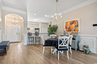 Dining area featuring crown molding and light hard
