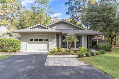 View of front of house with a garage and a front y