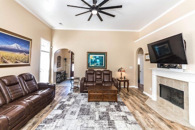 Living area with wood finished floors, arched walk
