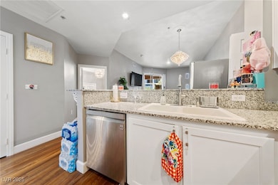 Kitchen with dishwasher, wood finished floors, a s
