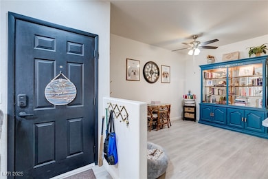 Foyer entrance with wood finished floors, baseboar