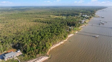 Bird's eye view featuring a water view and a woode