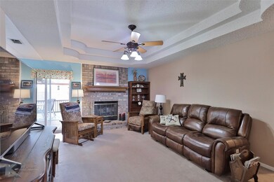 Living room featuring ceiling fan, carpet flooring