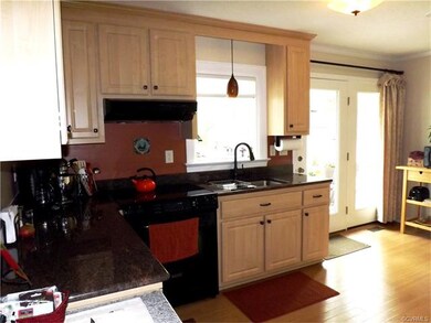 The kitchen has a glass top range, pantry & washer