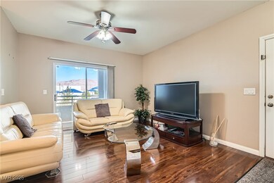 Living area with a ceiling fan and wood finished floors