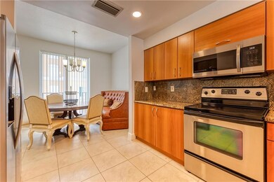 Large open kitchen with tile flooring and dining r