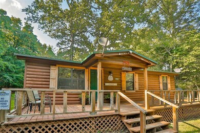 Front view of property featuring a wooden deck