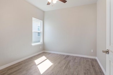 Spare room with a ceiling fan, light wood finishe