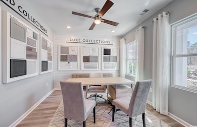 Dining room with a ceiling fan, light wood-style flooring, and recessed lighting