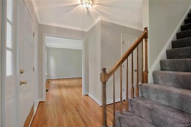 Foyer with fresh paint, newly refinished wood floo