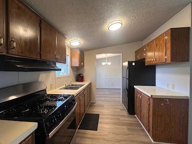 Kitchen with stainless steel gas range, under cab