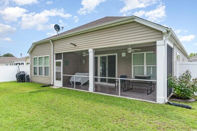Back of house featuring a patio, a lawn, and ceili