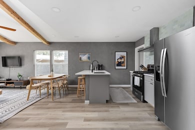 Kitchen with stainless steel appliances, wall chi