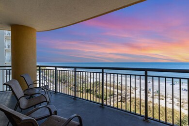 Balcony at dusk with a water view and a beach view