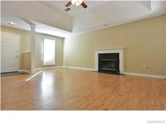 THE LIVING ROOM HAS A TRAY BOXED  CEILING MAKING T