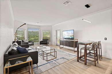 Living room featuring visible vents, wood finishe