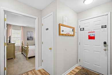 Doorway to outside with baseboards and light wood-