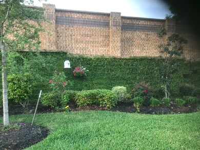BACKYARD PARADISE  No busy road here. Just the enchantment of your Secret Garden, hidden away behind this amazing brick privacy wall with stone accents.