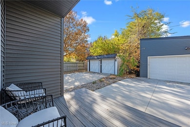 Wooden terrace with an outdoor structure and a detached garage