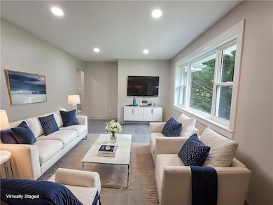 Living area with wood finished floors and recessed lighting