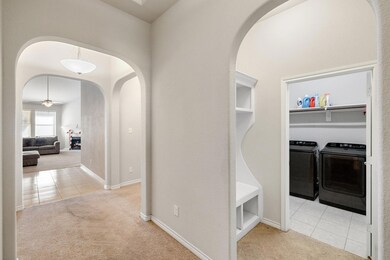 Entry Hall with light colored carpet and washing m