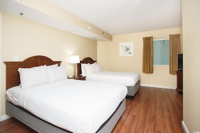 Bedroom with wood finished floors and baseboards