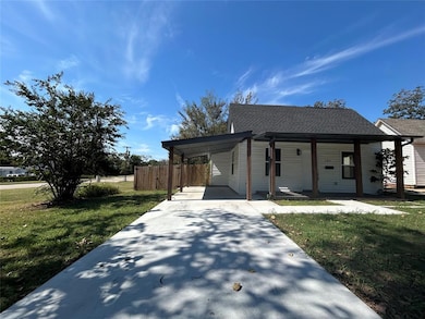 Driveway and carport leading to a classic bungalow entry.