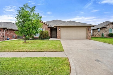 Ranch-style house with a shingled roof, driveway, brick siding, a garage, and a front lawn