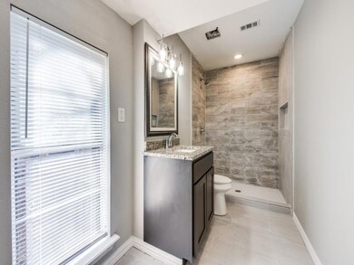 Bathroom featuring a wealth of natural light, tile