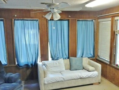 Great enclosed sunroom with ceiling fan.