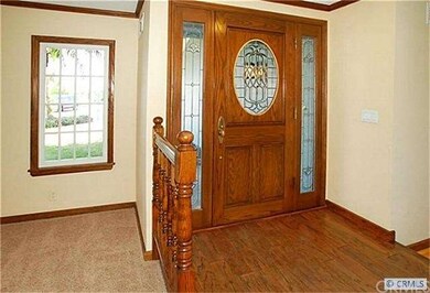 Raised entry from inside has oak door with leaded 