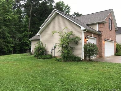 Sideview of property. Vinyl siding on three sides.